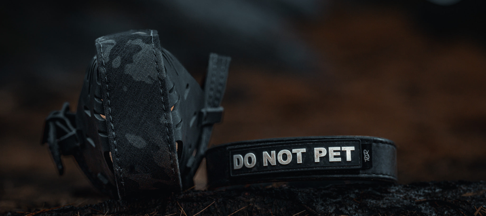 Black wrapped dog muzzle beside a DO NOT PET collar